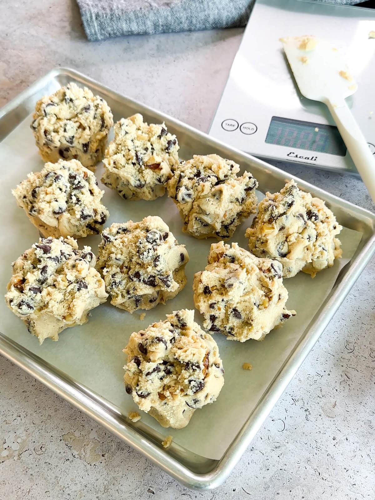 prepared dough balls for cookies on a baking sheet.