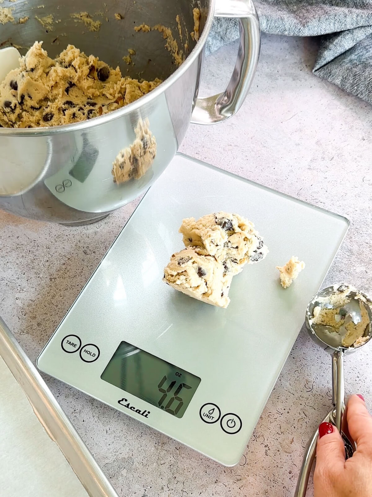 portioning large chocolate chip walnut cookies on a scale