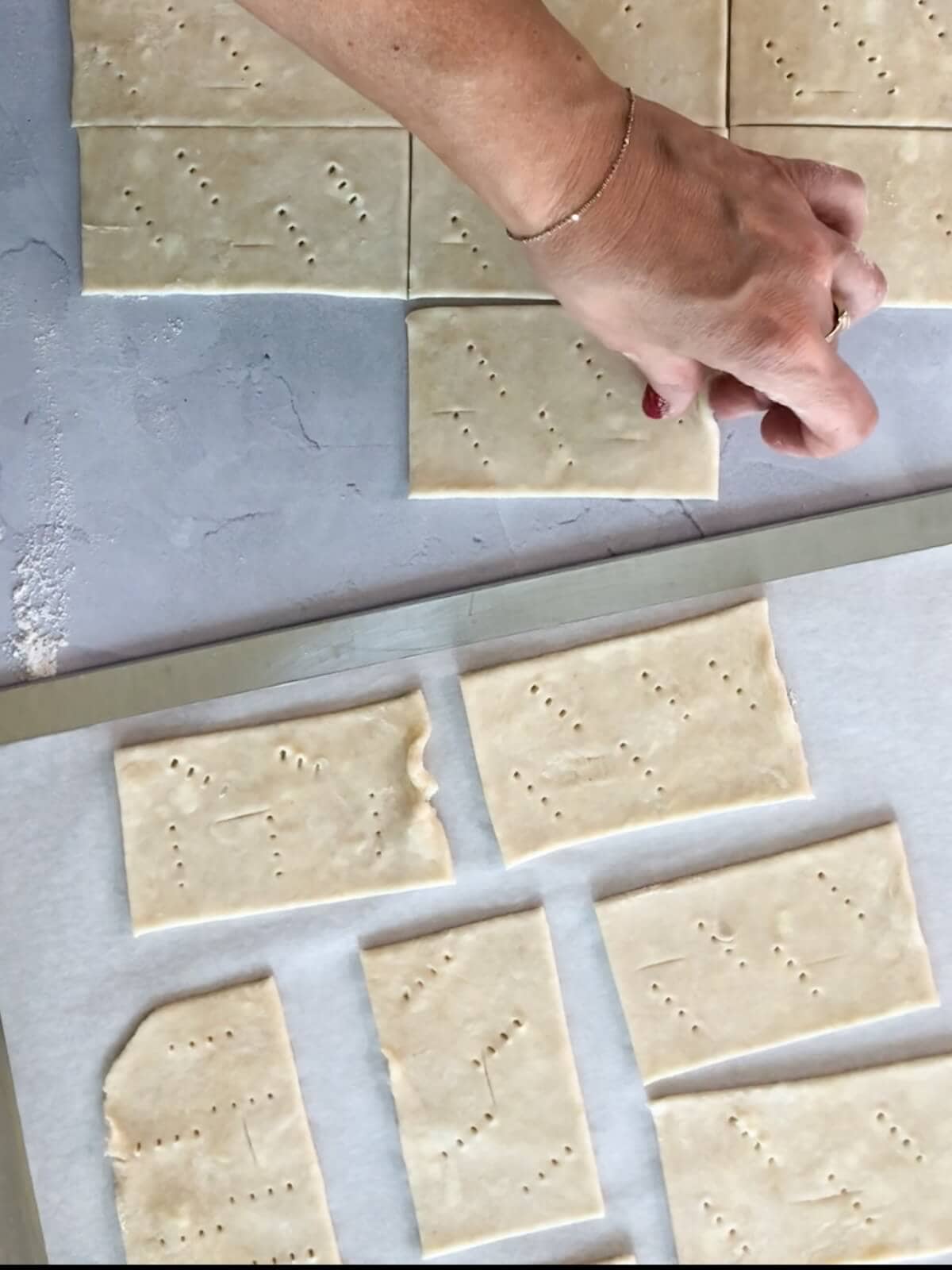 placing pastry squares on a parchment lined baking sheet.