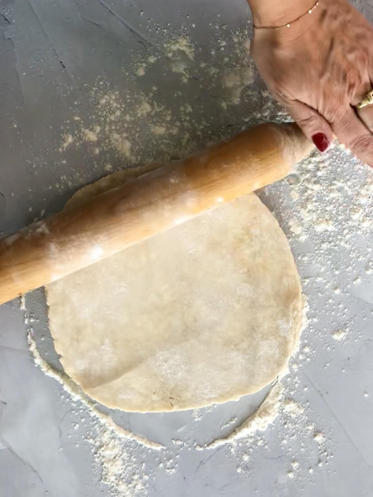 rolling pastry dough for mini apple tarts.