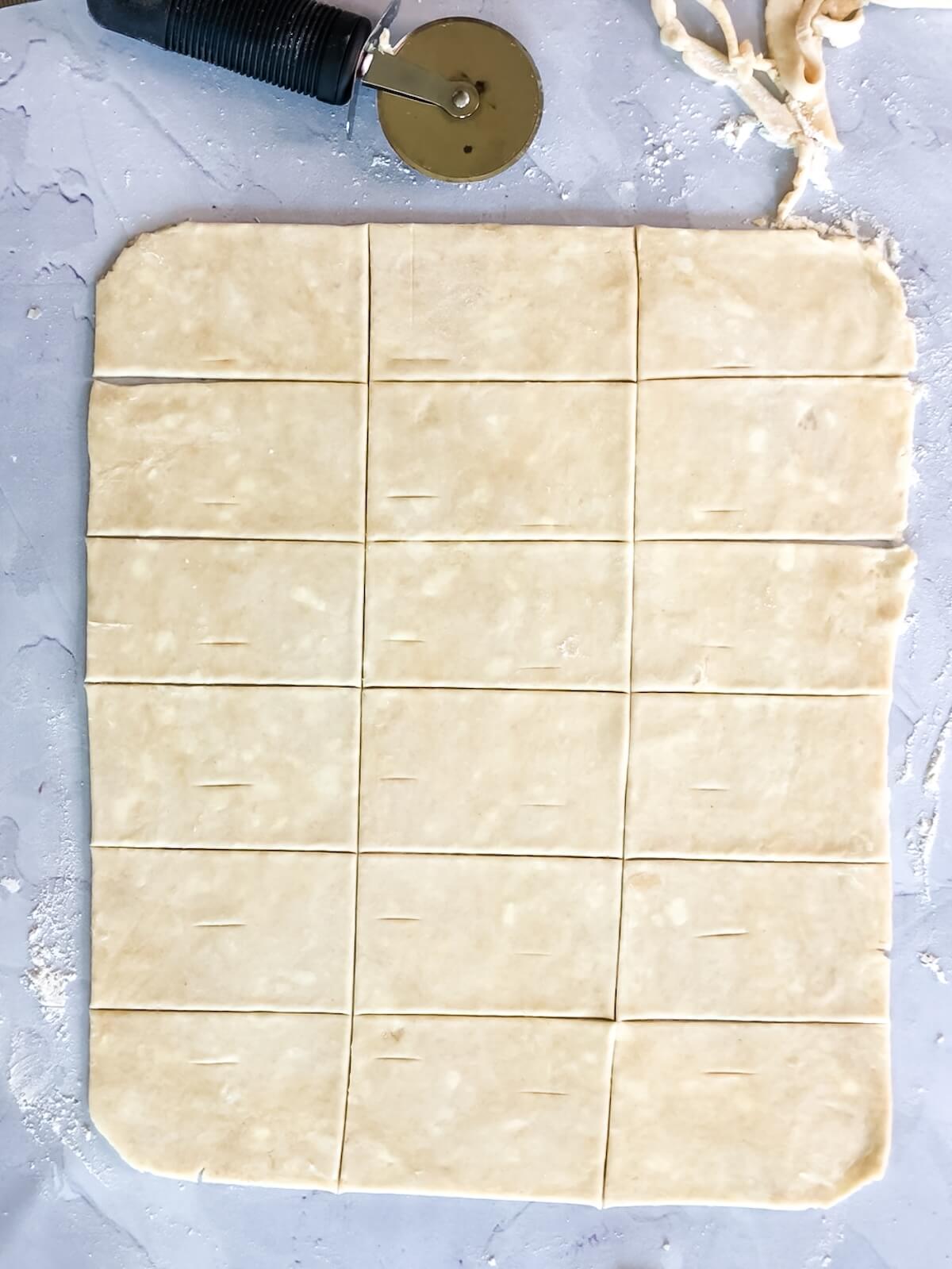 pastry dough cut into rectangles for mini apple tarts with blue cheese.
