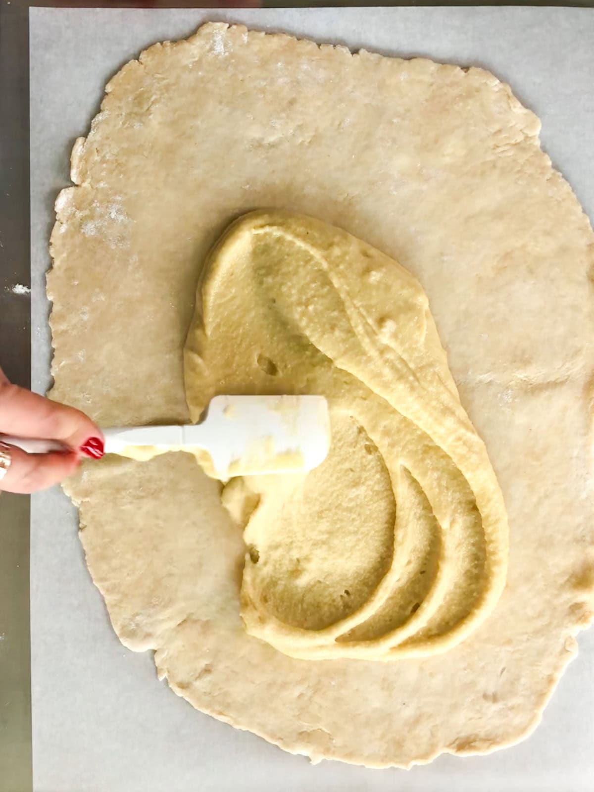 spreading frangipane on rolled out pastry crust.