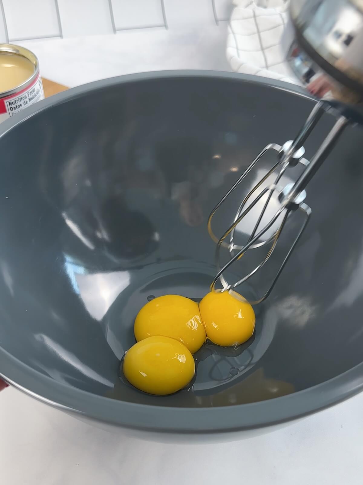 With a hand mixer, whip egg yolks until super light and fluffy for key lime pie.