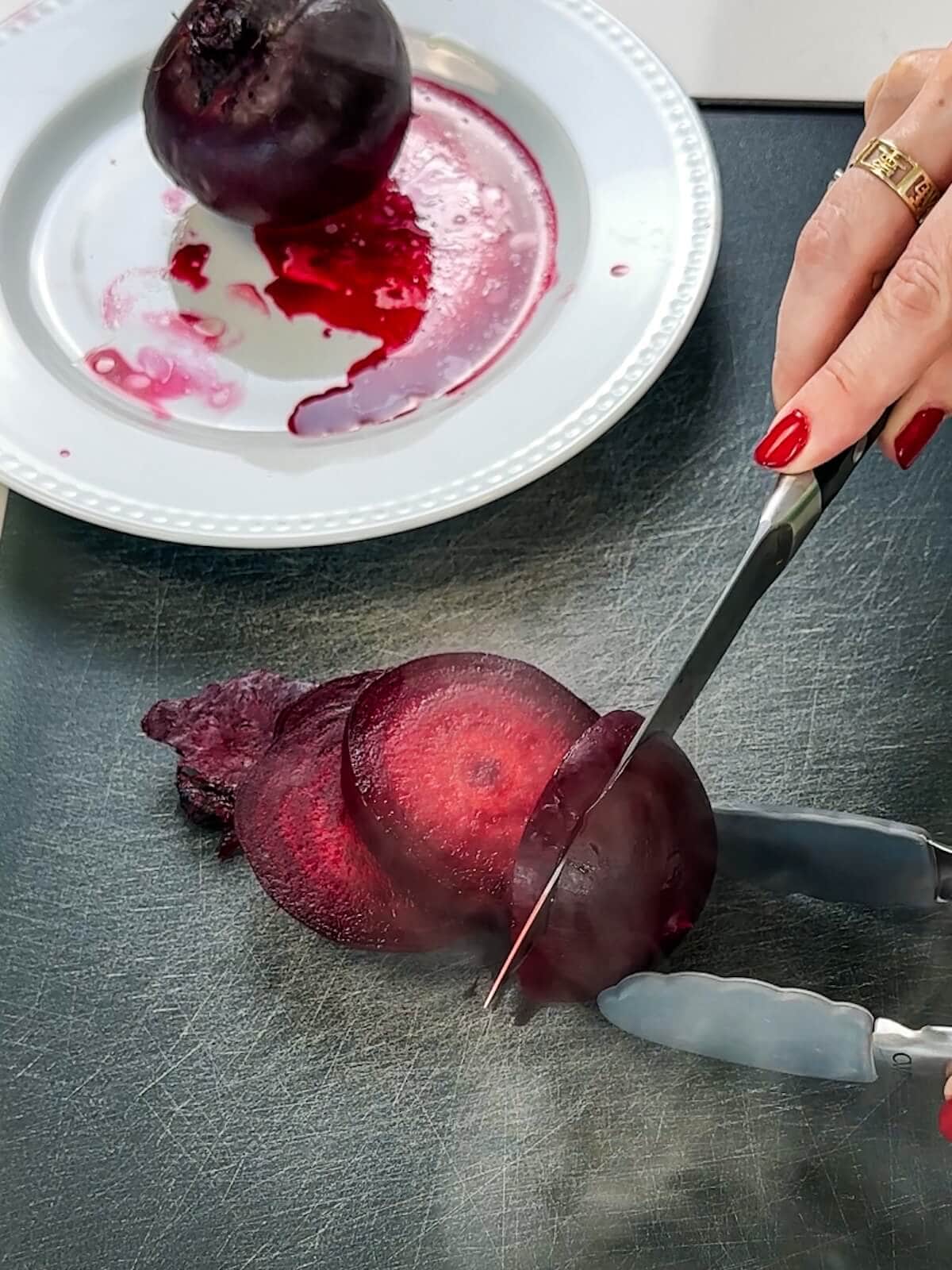 Slice cooked beets for roasted beet carrot salad.