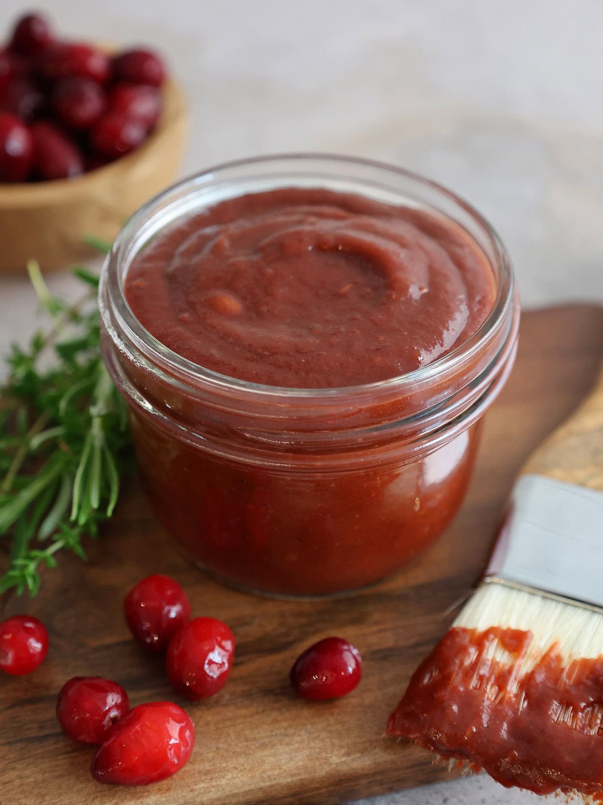 A small glass jar of cranberry bbq sauce.