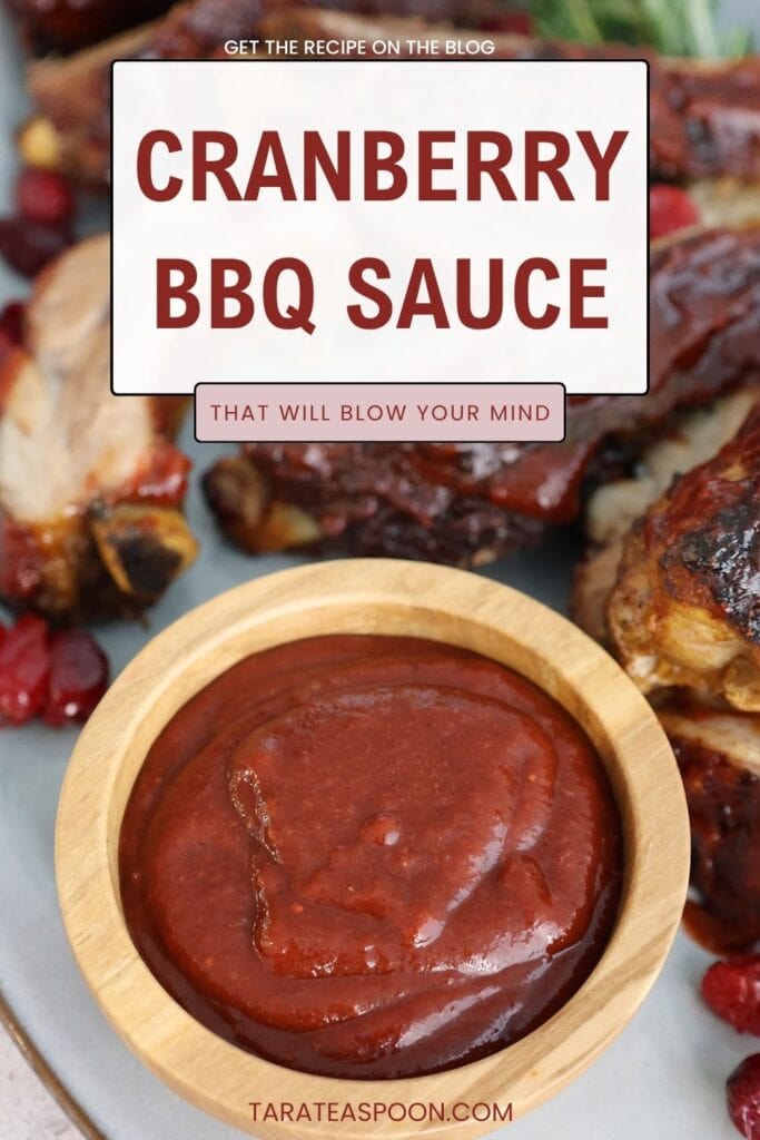 homemade cranberry barbecue sauce in a bowl with ribs pin graphic