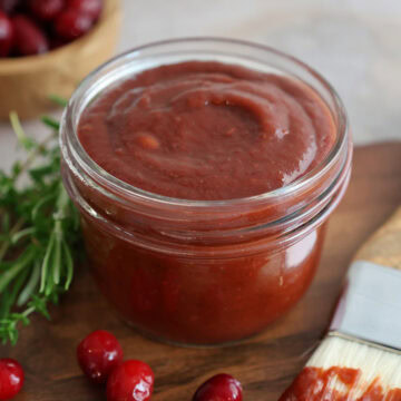 A small glass jar of cranberry bbq sauce.