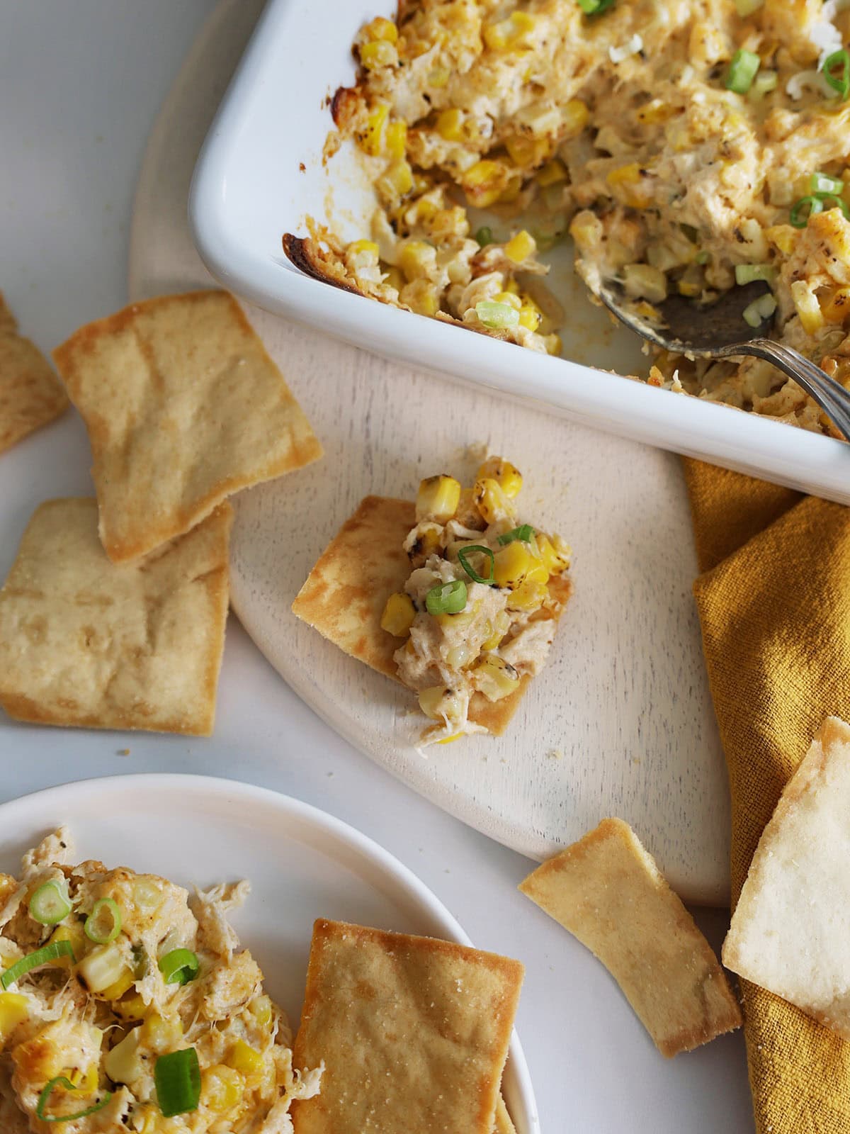 Close up of crab dip on a pita chip.