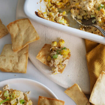 Close up of crab dip on a pita chip.