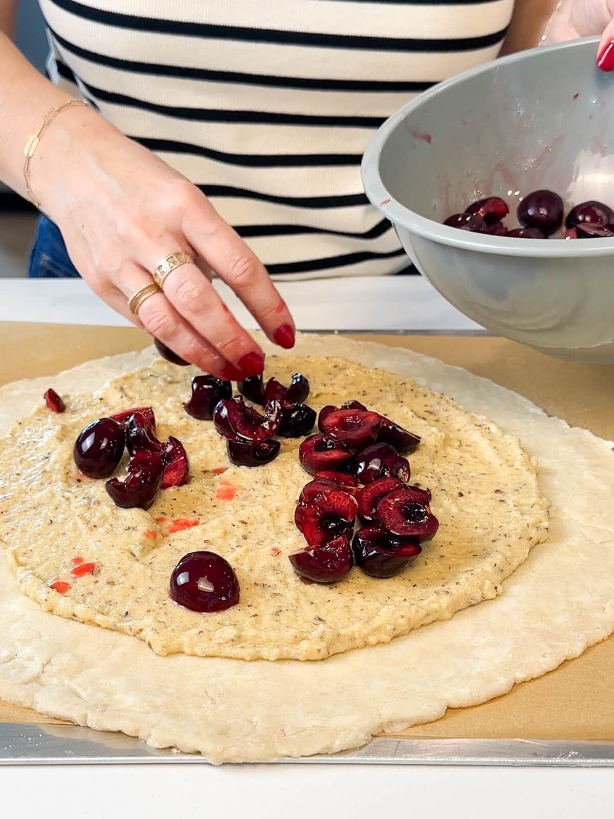 Pastry dough covered with frangipane and sweet cherries.