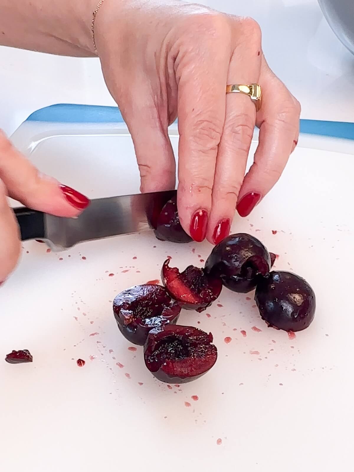 Cutting cherries in half.