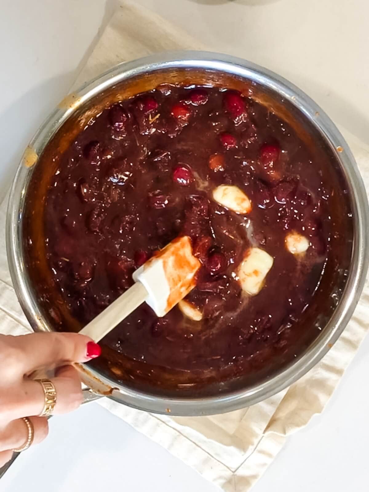 Cold butter being mixed into a bowl of other bbq sauce ingredients.
