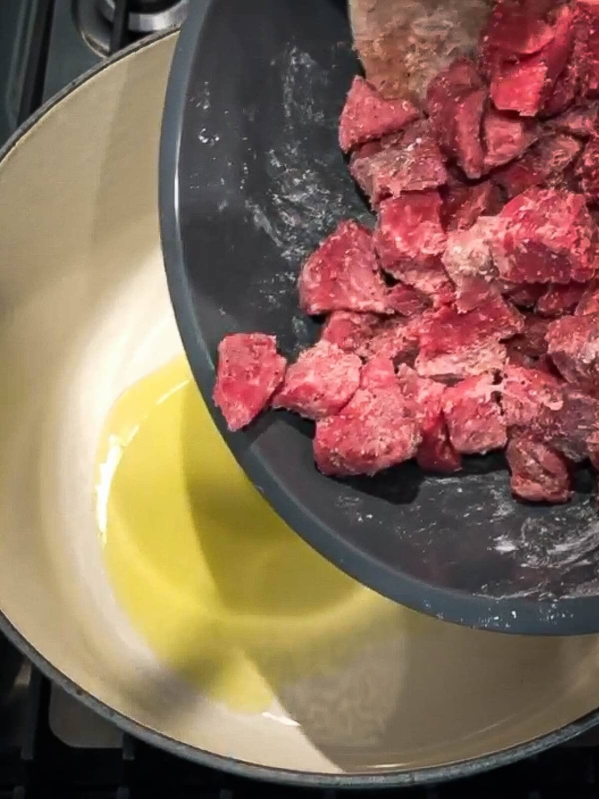 Cooking beef in batches for stew.