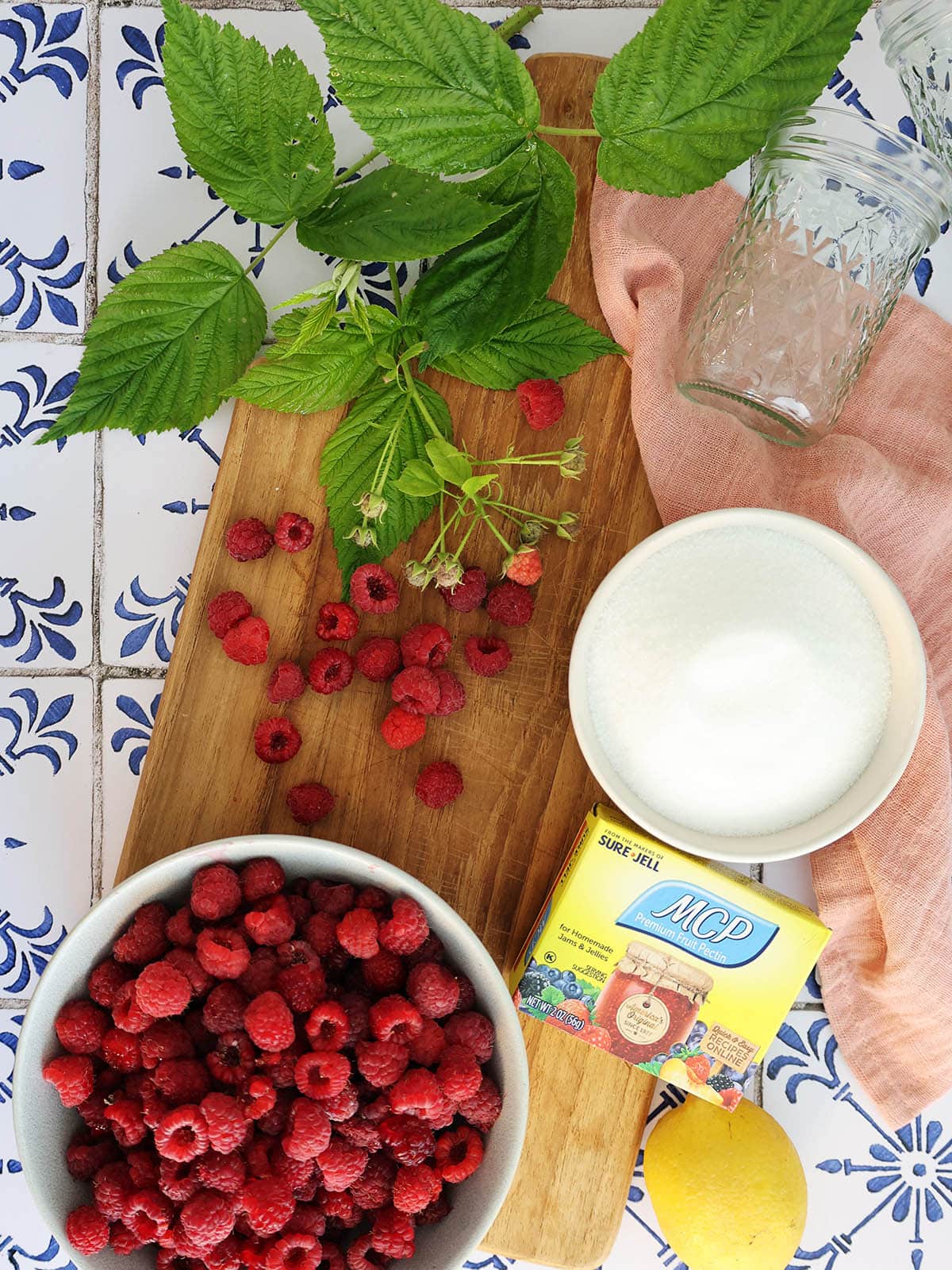 Ingredients needed to make raspberry freezer jam.