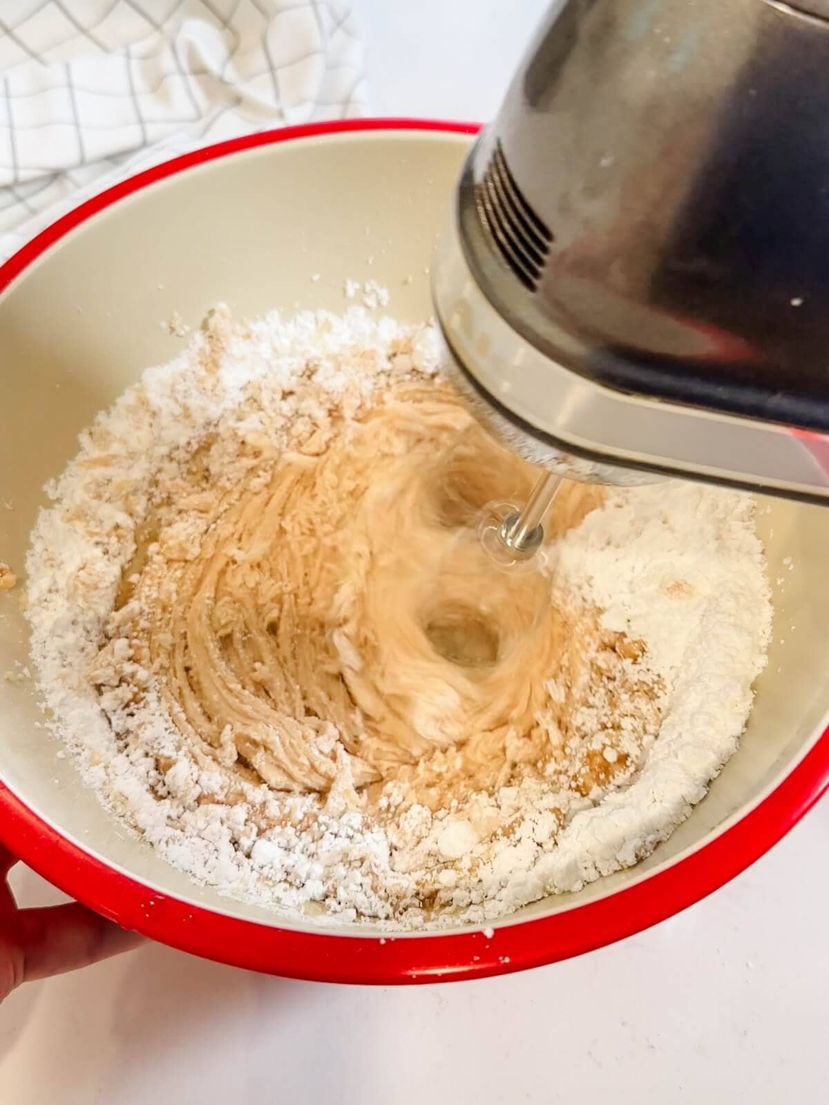mixing browned butter with confectioners sugar for frosting.
