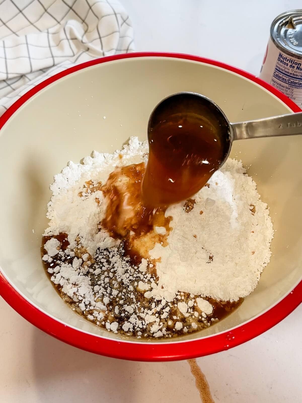 adding browned butter to confectioners sugar to make frosting.