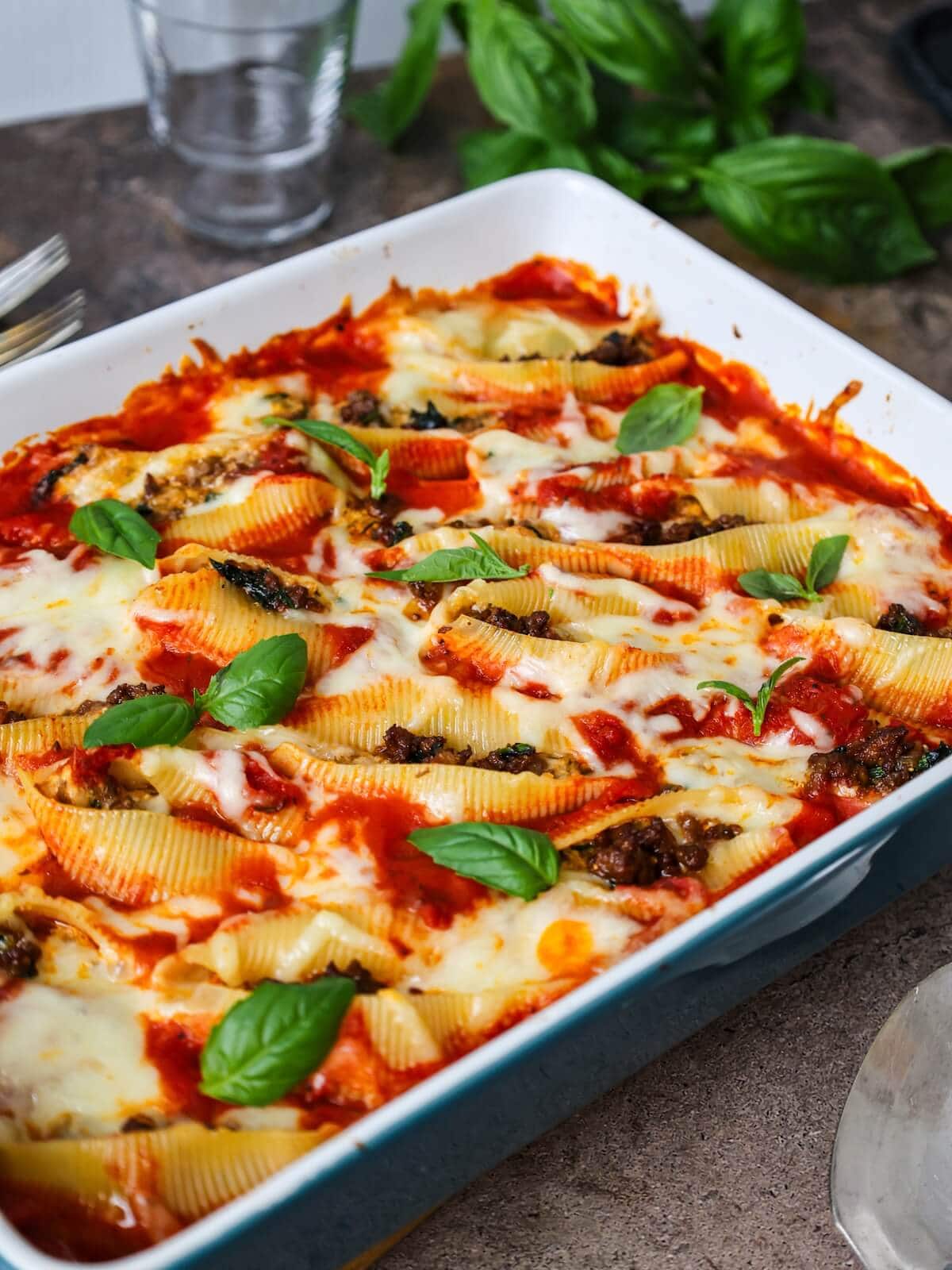 A baking dish filled with beef and ricotta stuffed shells.
