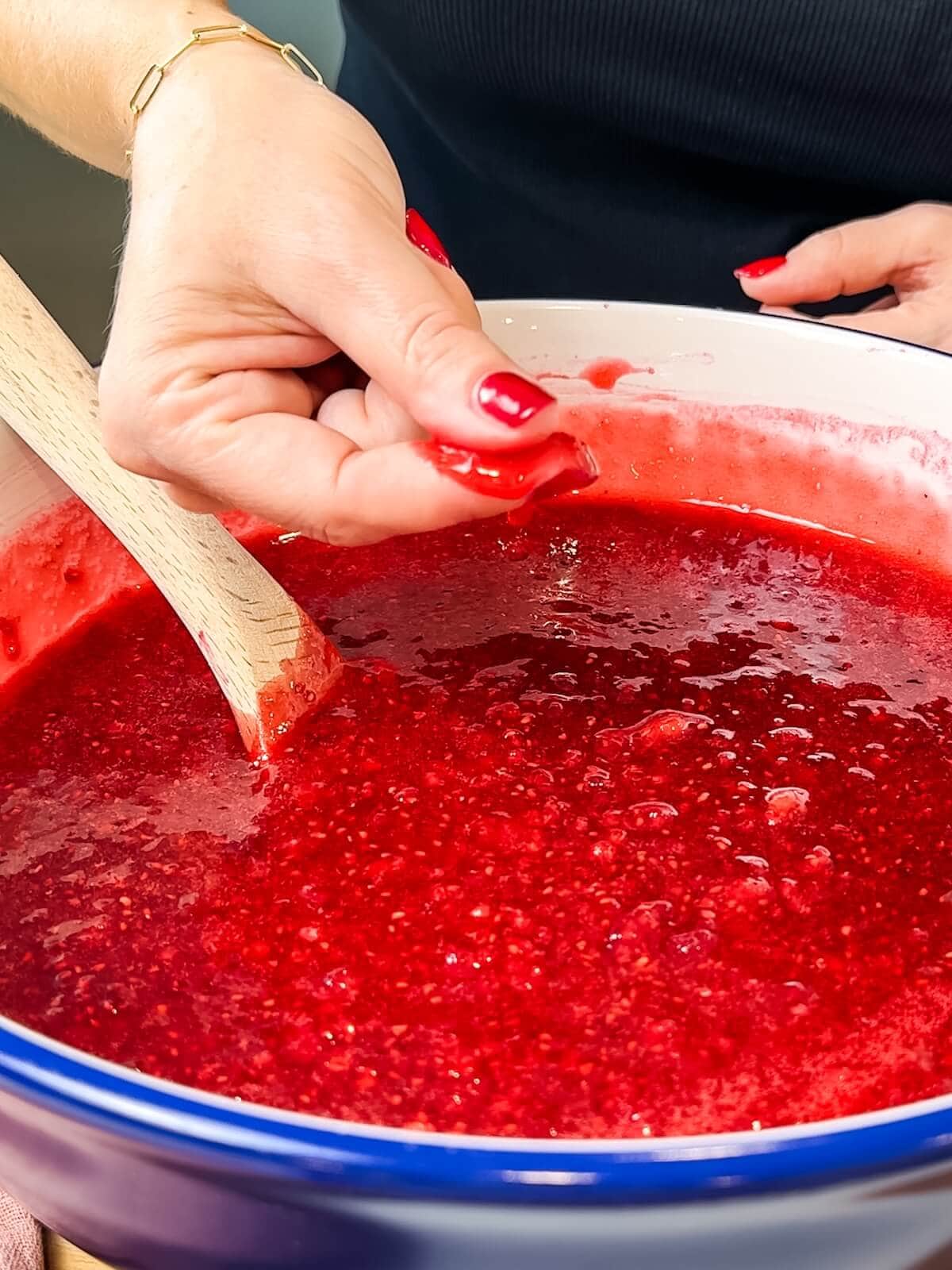 checking for dissolved sugar by rubbing jam mixture between two fingers.