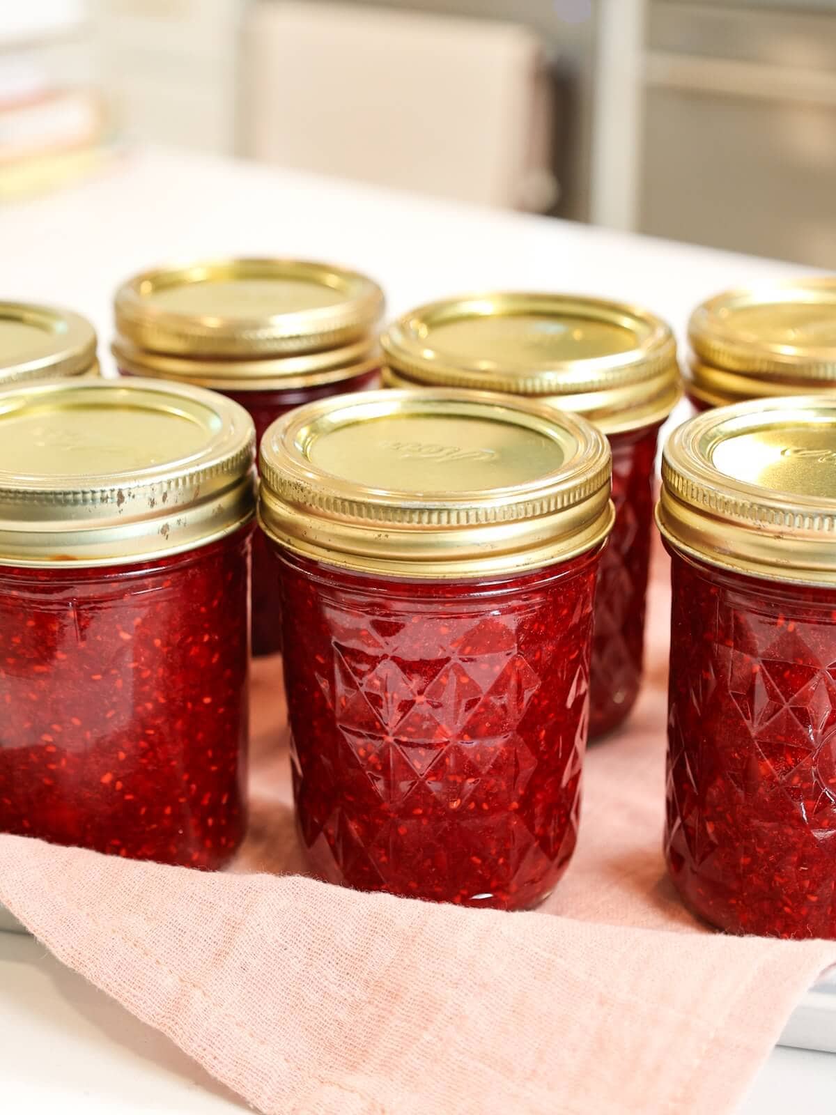 jars of jam sitting at room temperature for 24 hours until set.