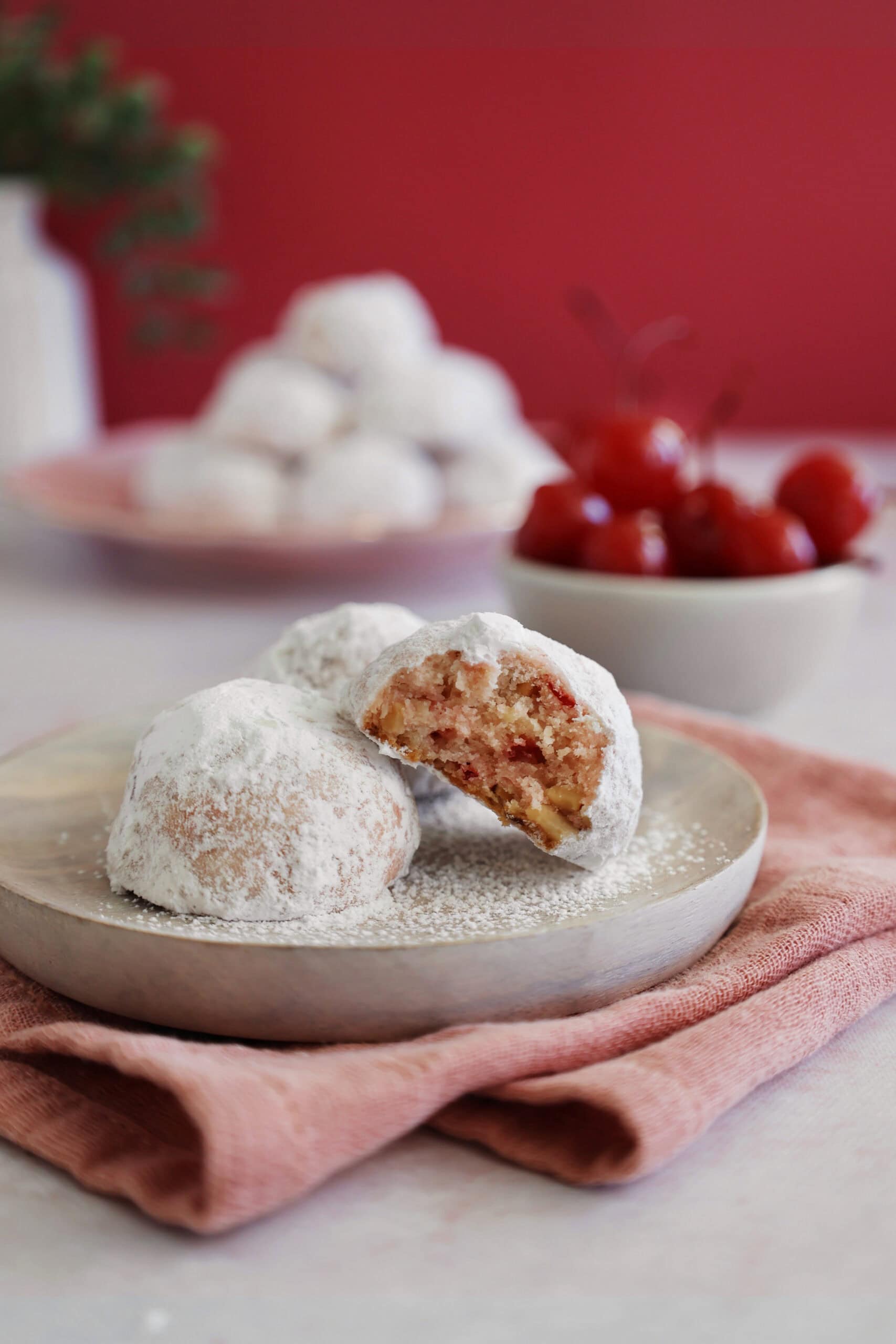 Close up of three cherry almond cookies with a bite taken out of one cookie.