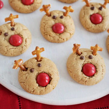 Close up of a plate covered with Rudolph reindeer cookies.