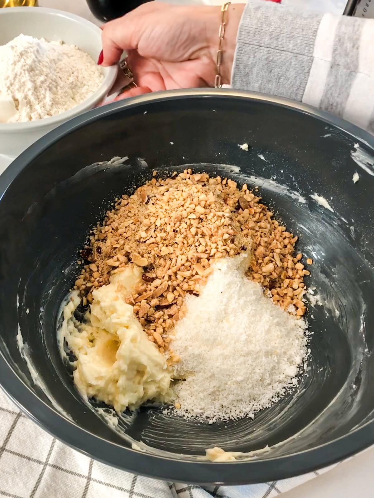 Butter, almonds, and shredded coconut in a mixing bowl.