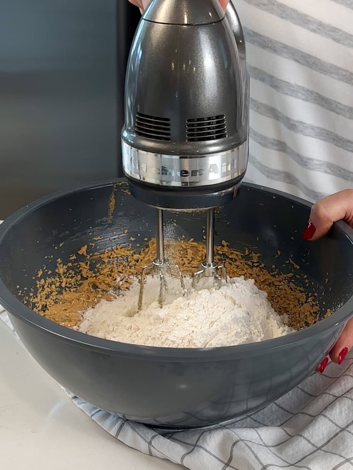 After adding the eggs, add the dry ingredients to peanut butter cookie batter.