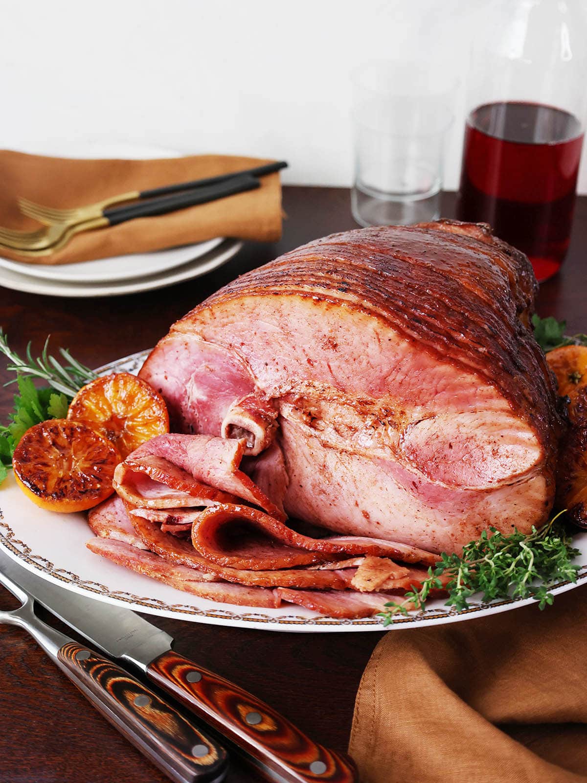 A roasted ham with honey glaze on a platter.