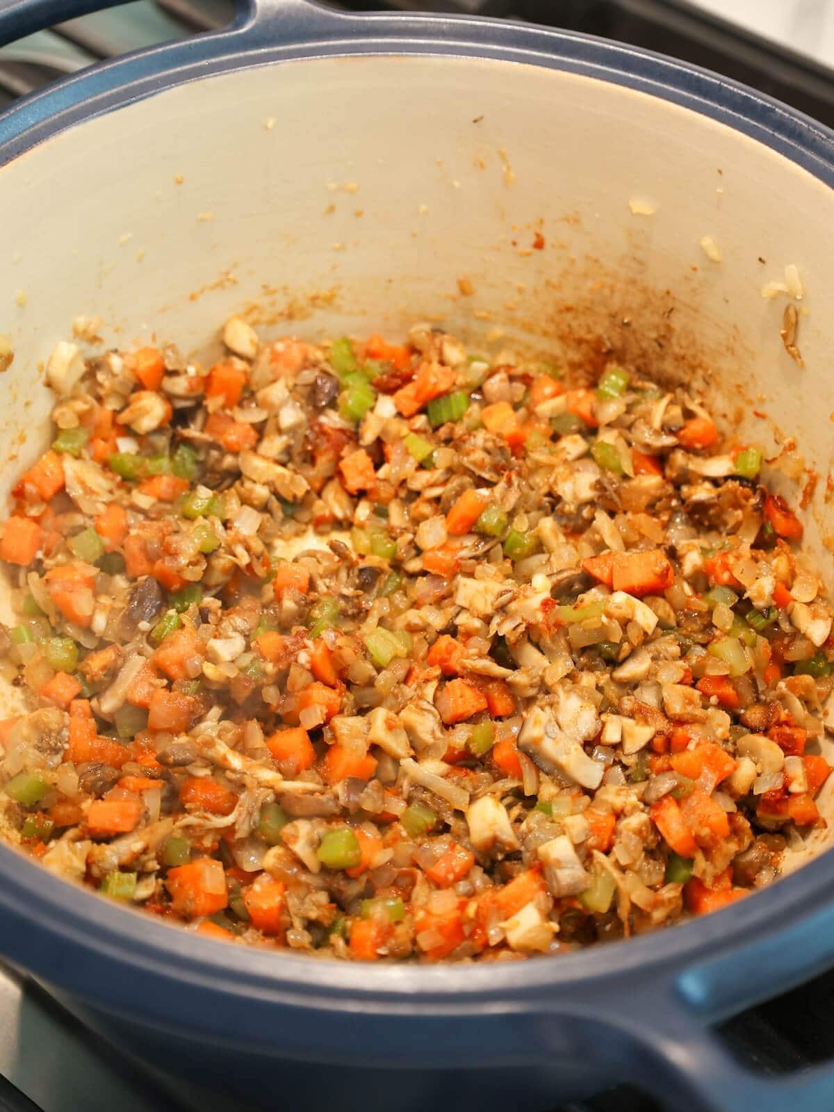 Cook mushrooms and mirepoix until mixture is just turning golden and fragrant.