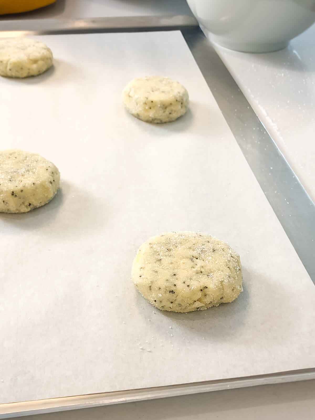 cookie dough balls should be about ½ inch thick before baking.