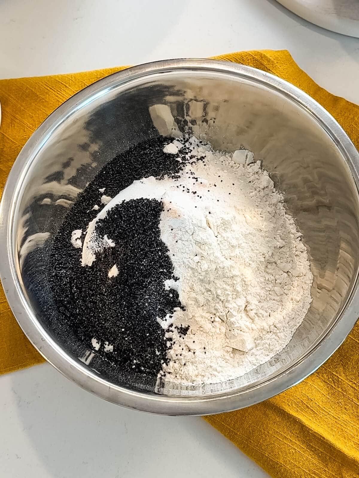 combining dry ingredients in a bowl for lemon poppyseed cookies.