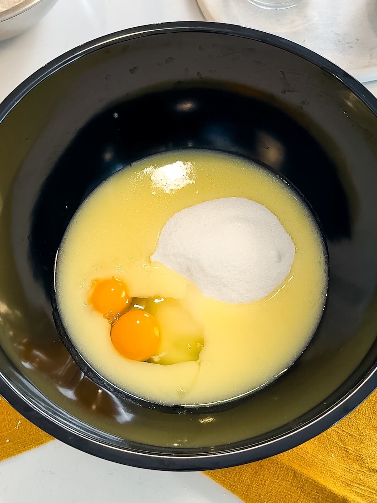 combining butter, lemon juice, eggs, sugar and extract in a mixing bowl for lemon poppyseed cookies.