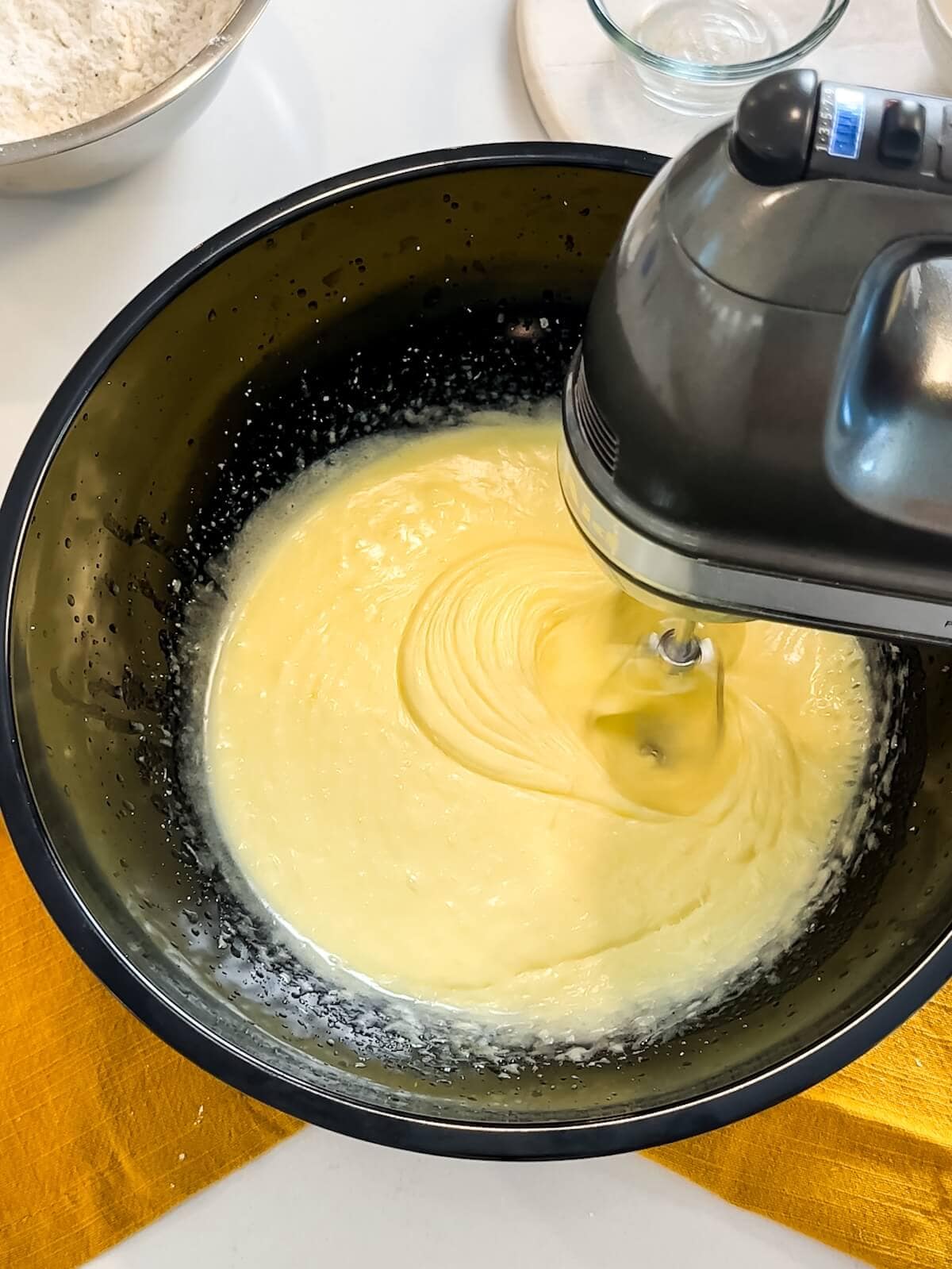 whipped liquid ingredients in a mixing bowl, lightened in color.