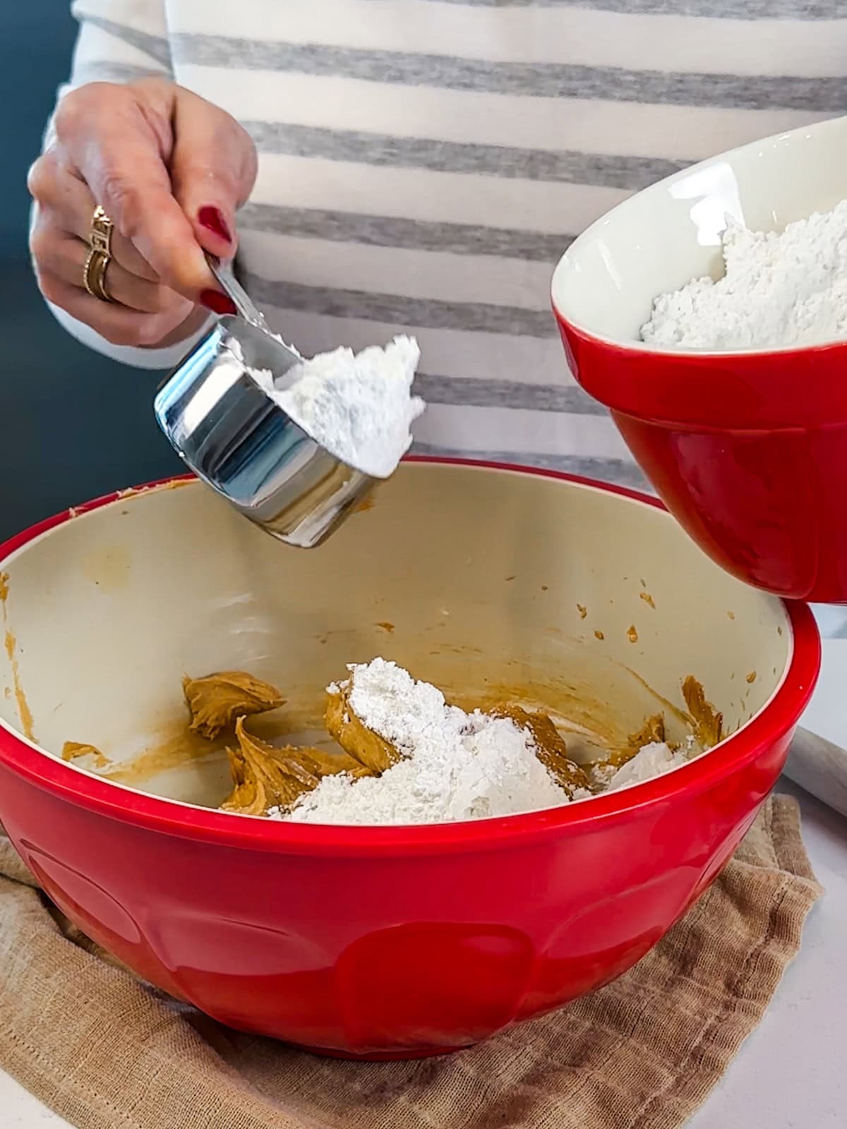 Add confectioners' sugar a little at a time to the bowl.