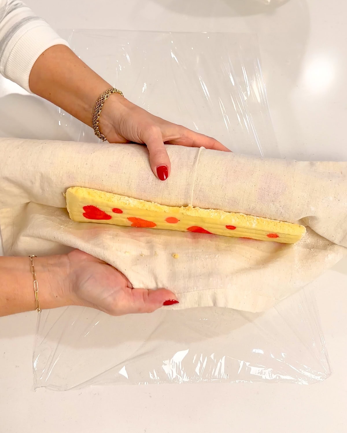 unrolling cooled cake from towel.