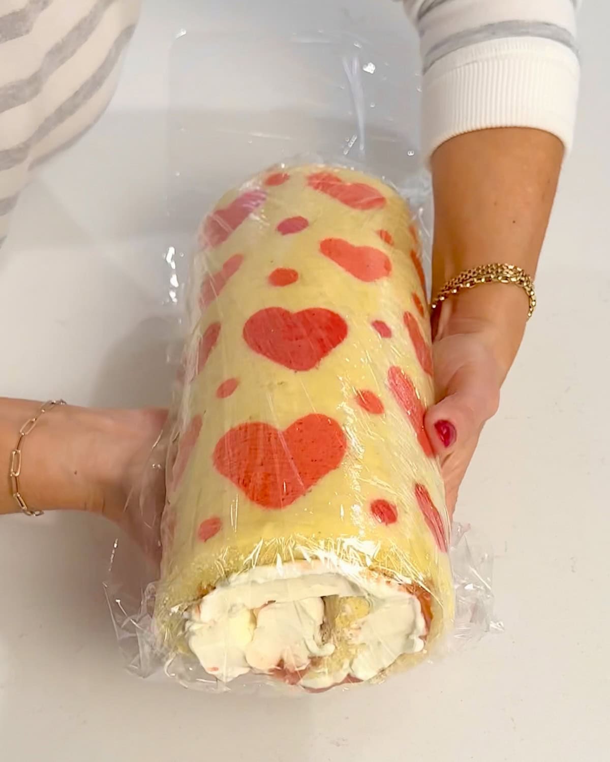 wrapping cake roll in plastic wrap to chill.
