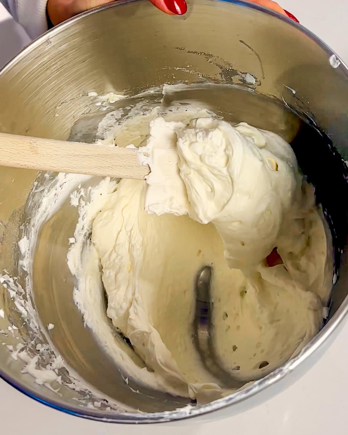 folding whipped cream into cream cheese and sugar mixture.