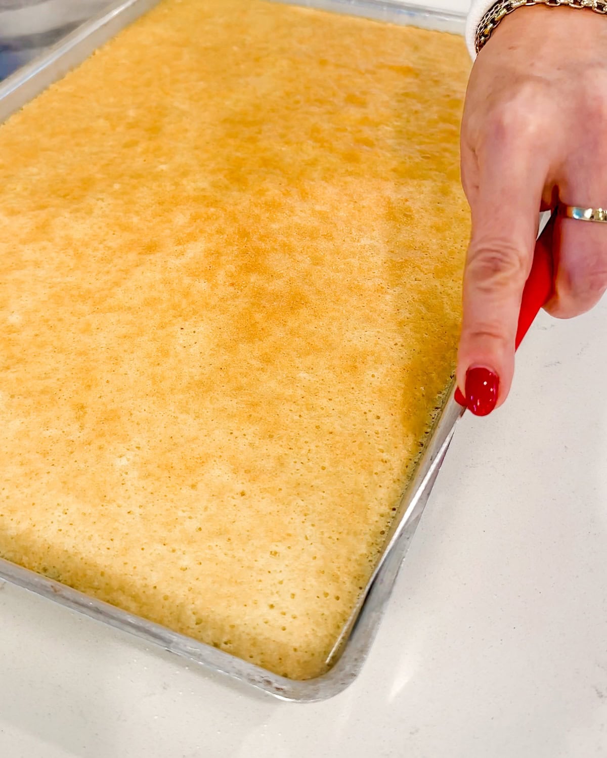 running a knife around the edge of the cake to remove from pan.