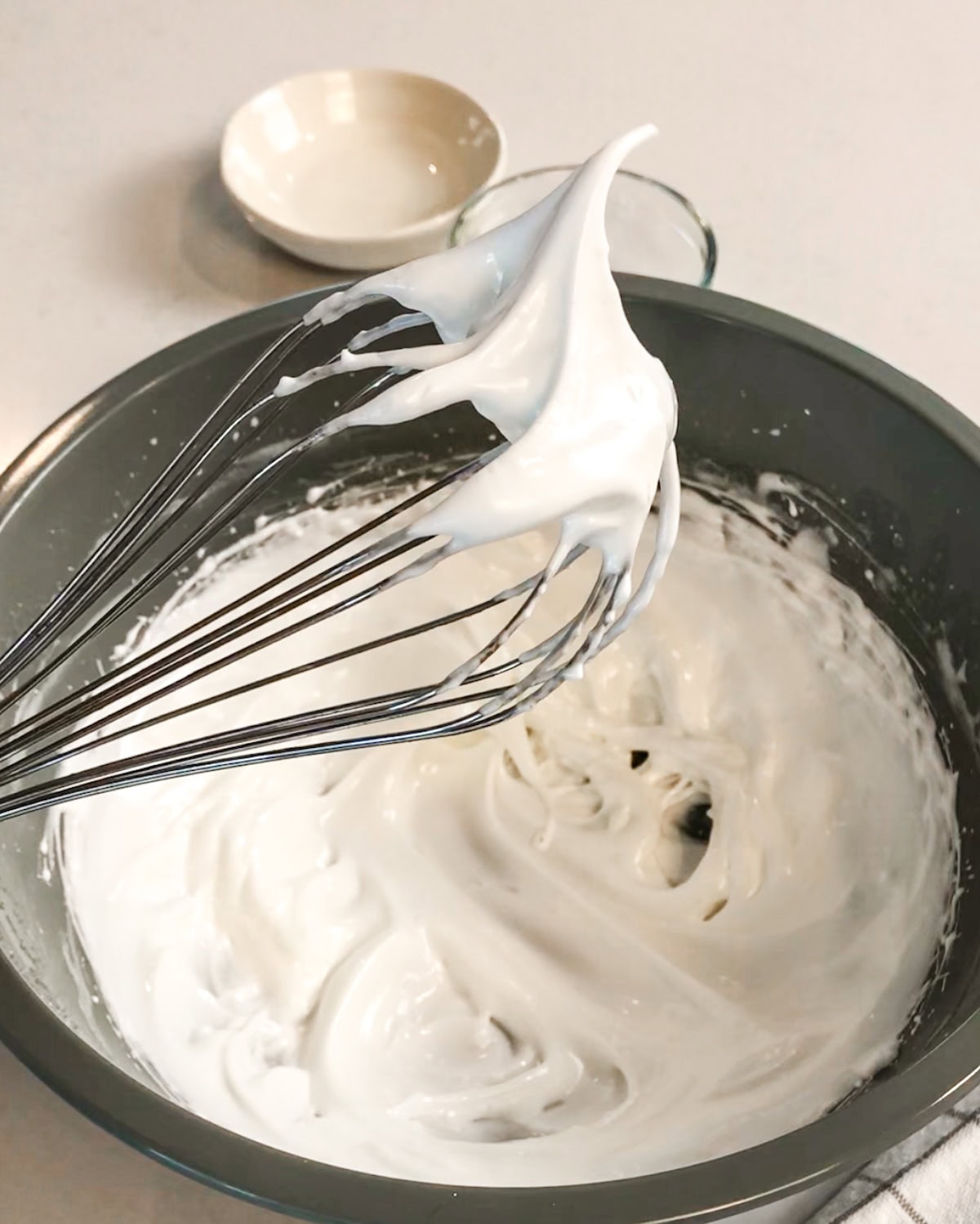 Whip egg white mixture to firm peaks for the hearts on a Valentine's cake roll.