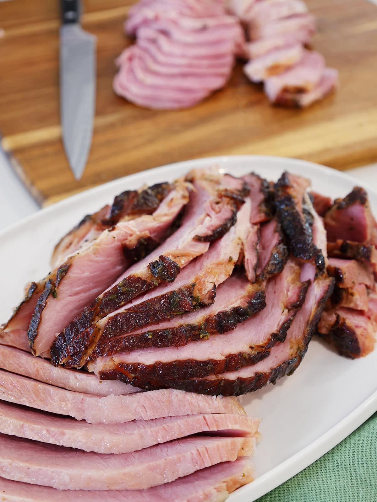 Sliced ham on a serving tray.