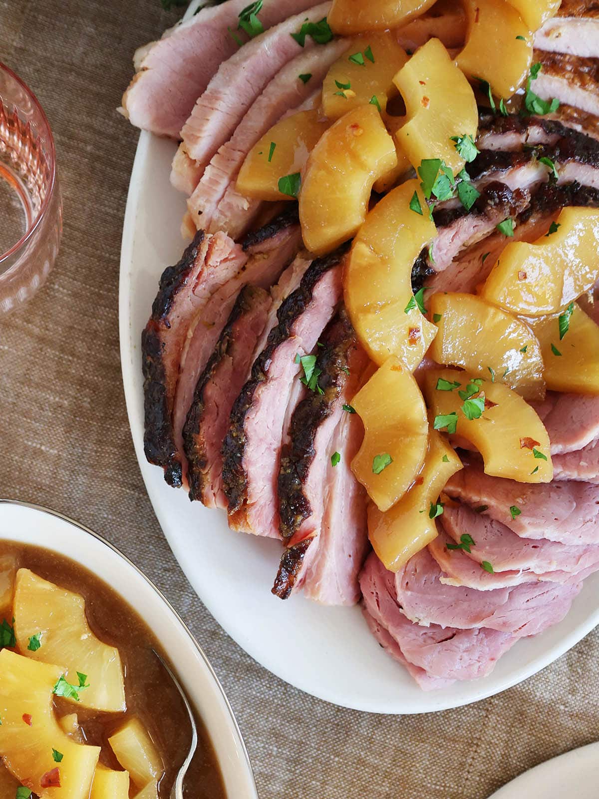 Overhead view of a roasted ham topped with pineapple.