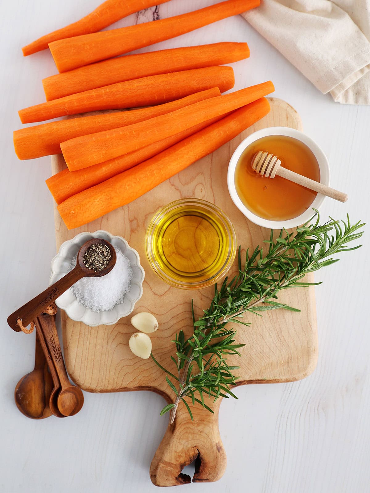 Ingredients for honey roasted carrots with rosemary.