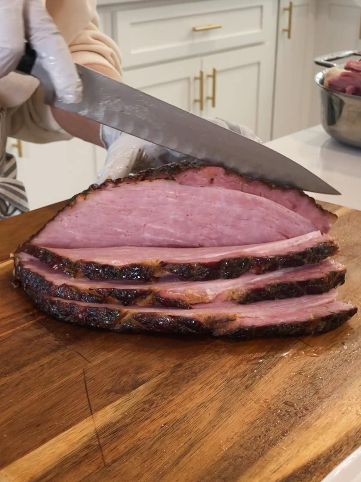 Slicing a section of roast ham for serving.