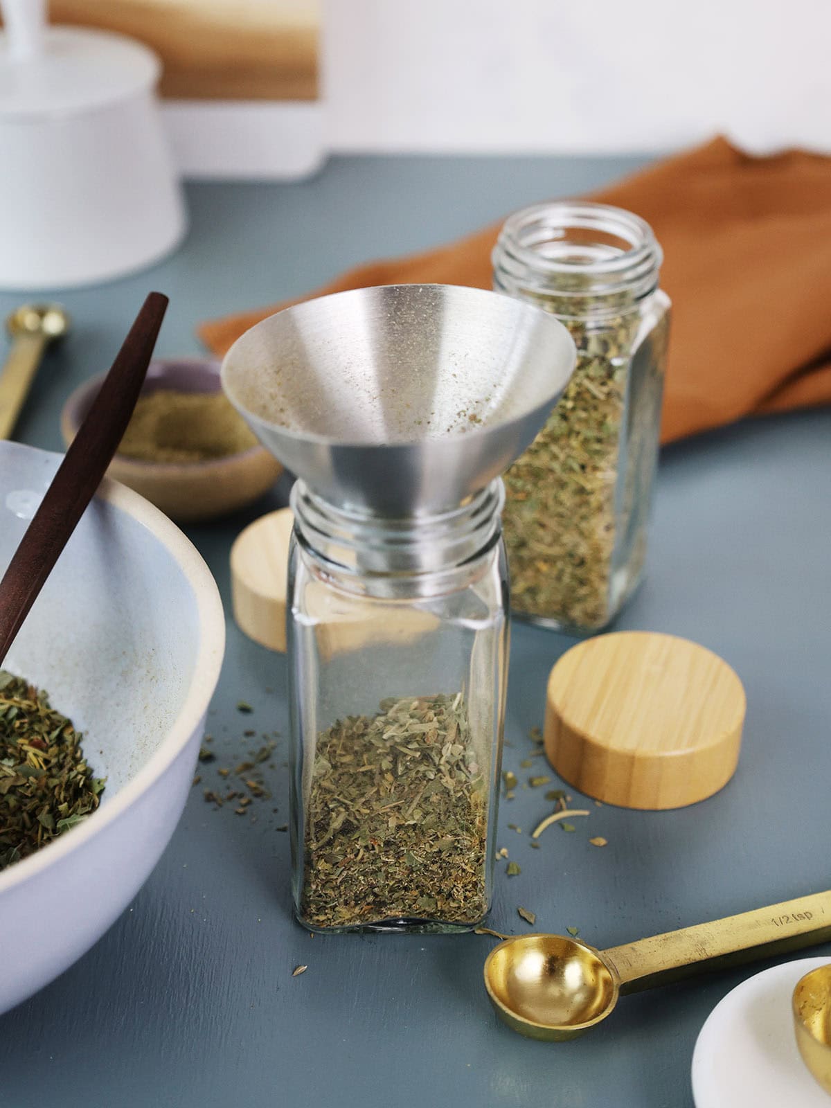 A small funnel in the top of small spice bottle.
