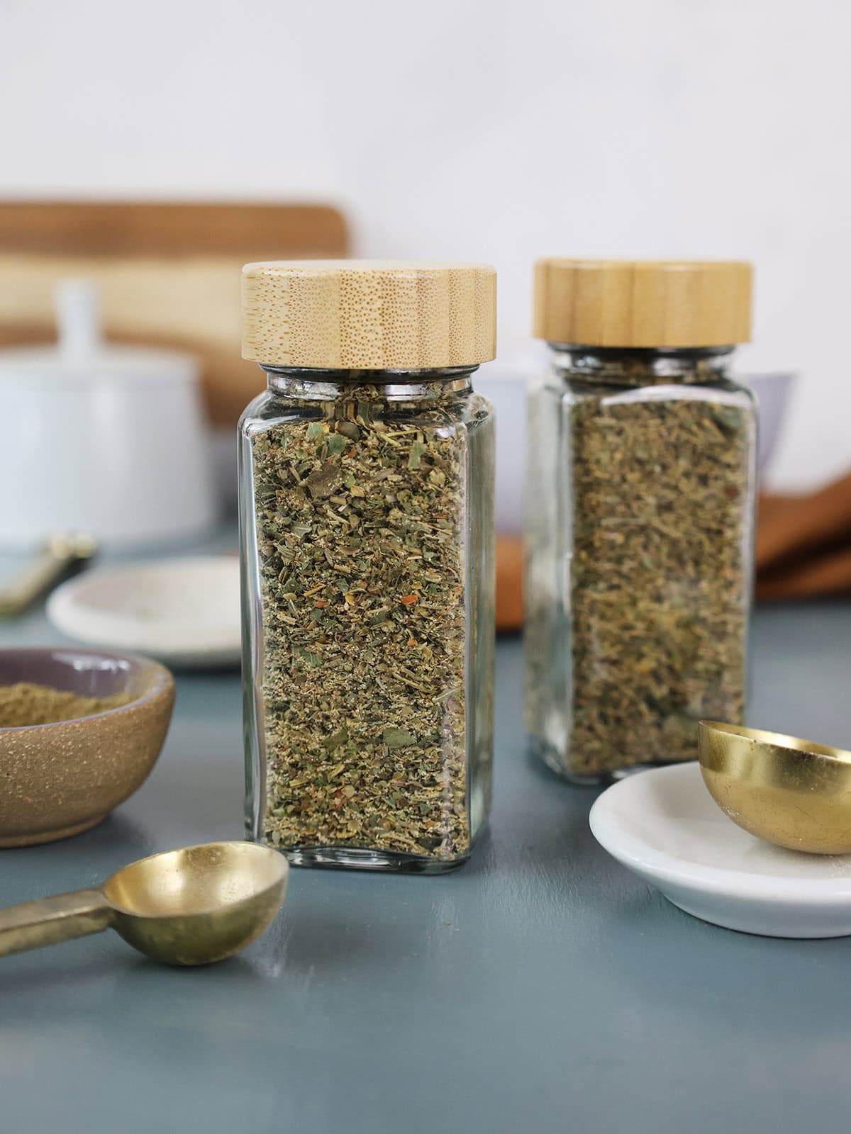 Two jars of Italian spice seasoning.