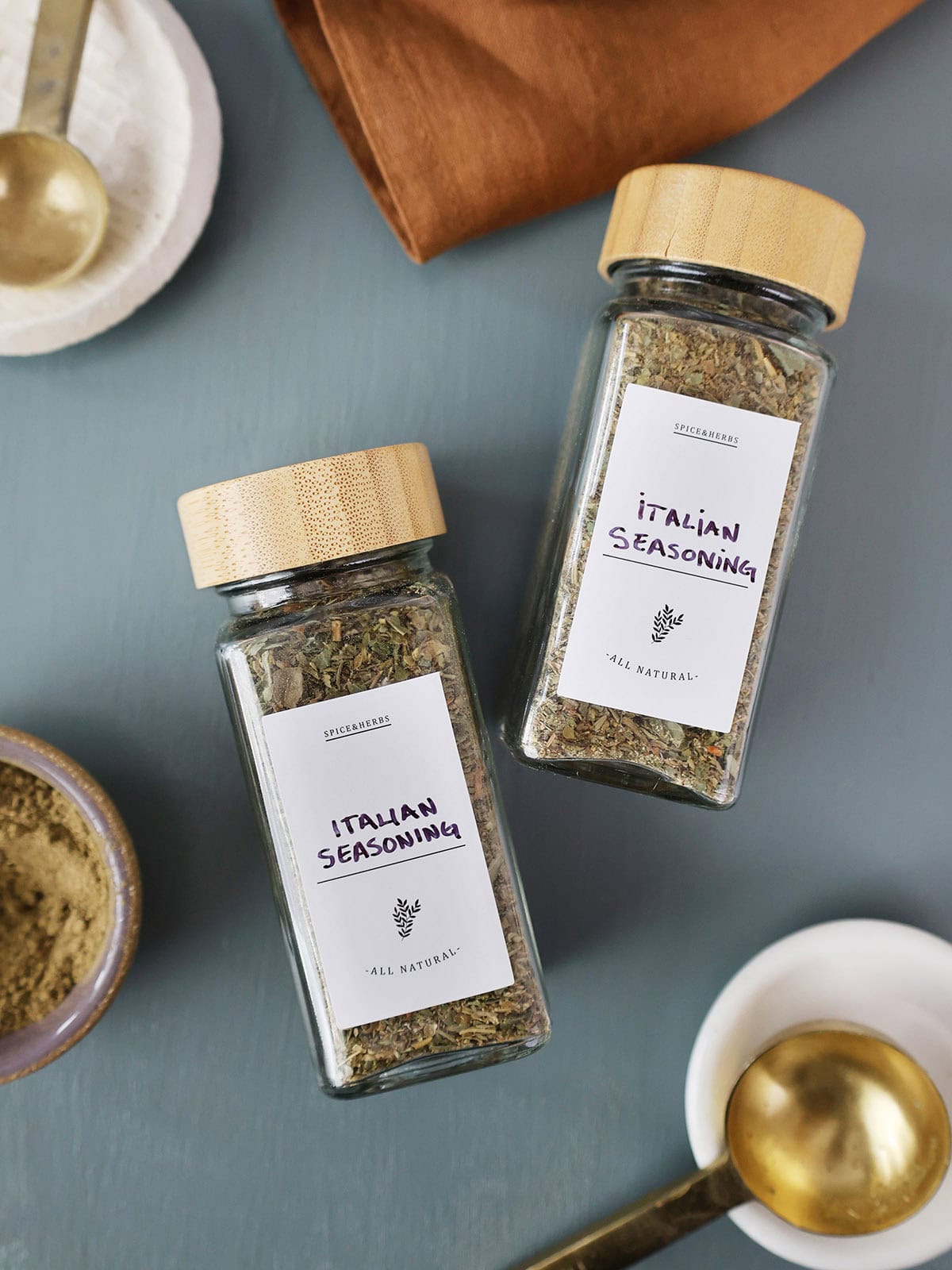 Two bottles of Italian seasoning with labels.