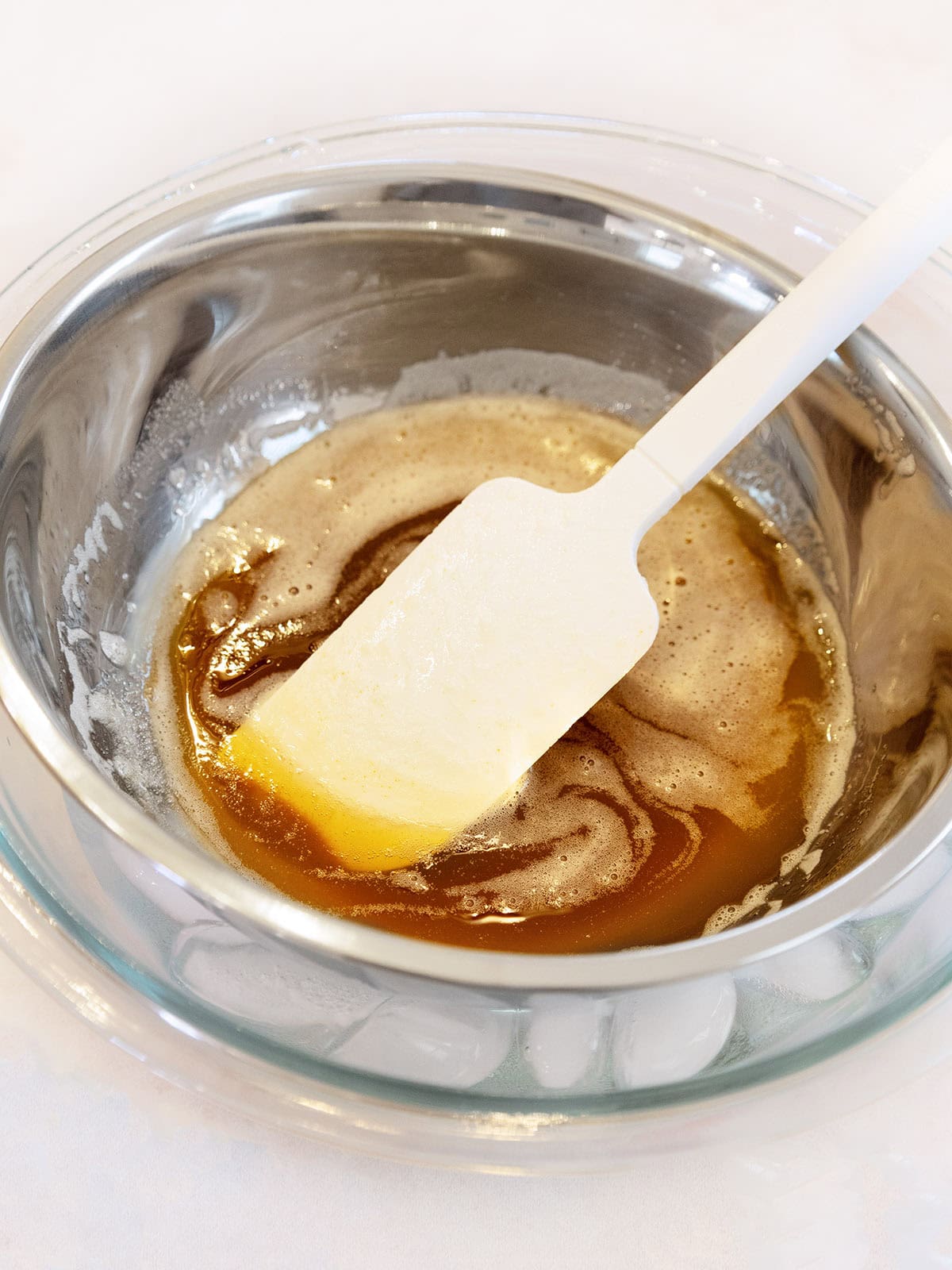 A silver bowl filled with browned butter.