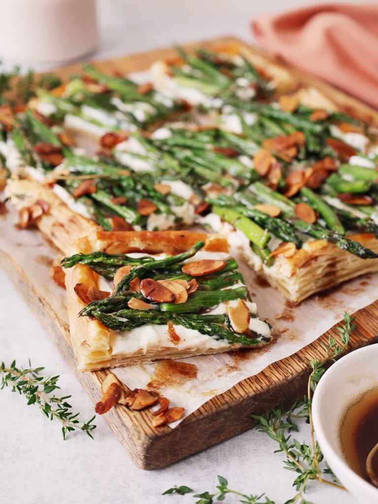 A tart made with brown butter on a cutting board.