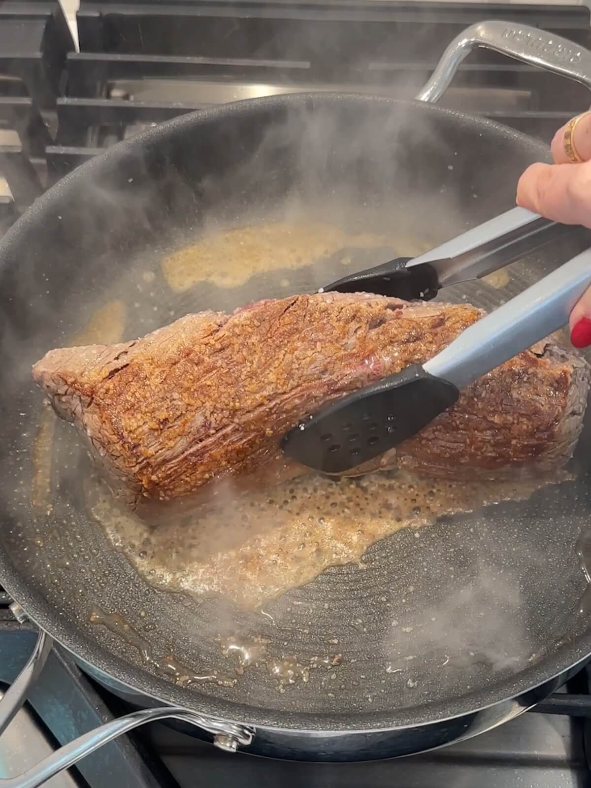 turning beef tenderloin in a skillet to brown it on all sides.