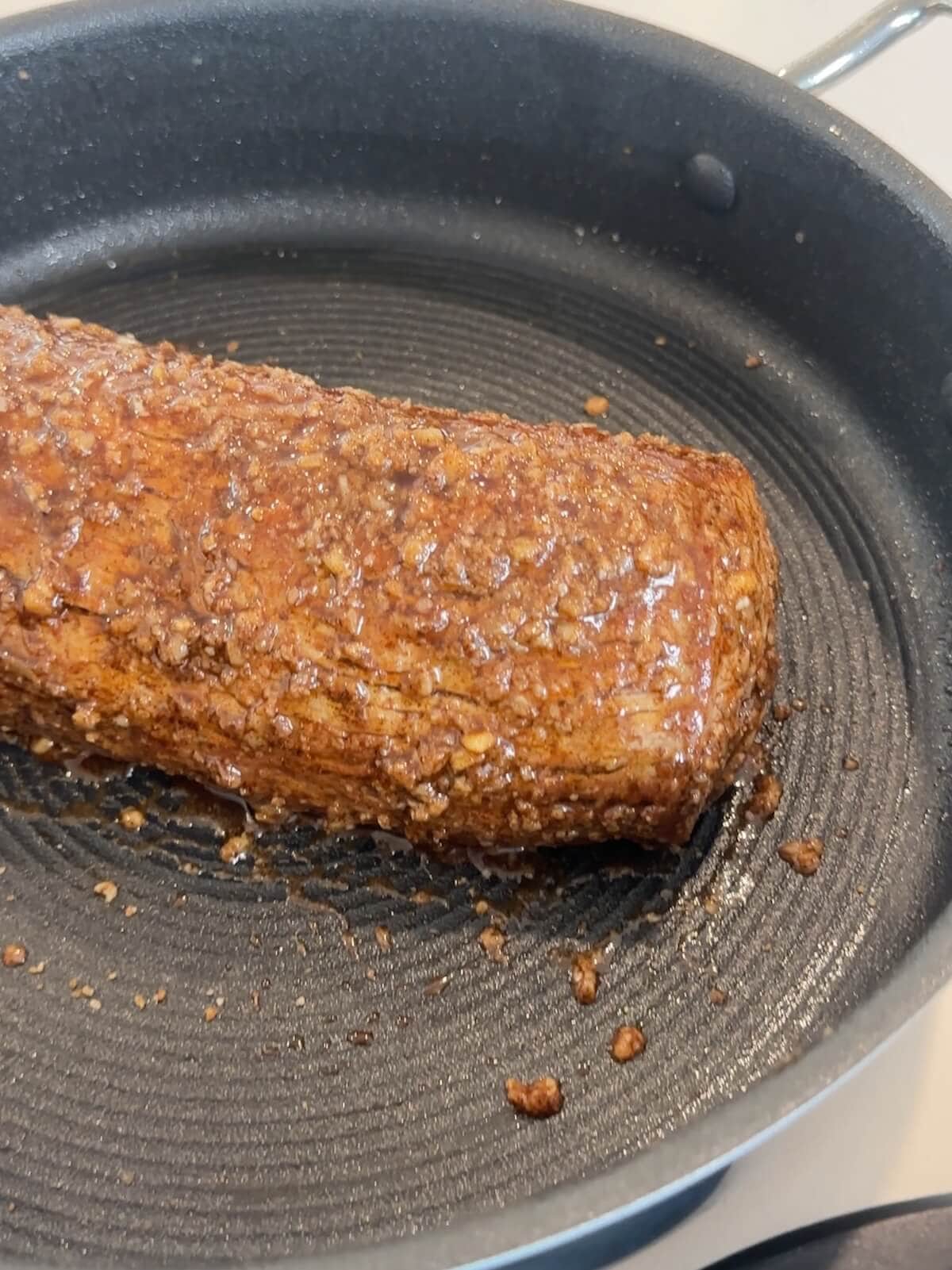 beef tenderloin in oven proof skillet ready to roast.